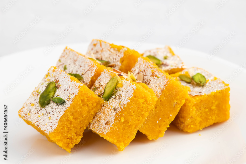Famous Indian Mithai Meetha Mung Daal Barfi Or Moong Dal Burfi Barfee Made Of Yellow Gram Flour In Desi Ghee Mixed With Mawa Pistachio And Khoya. Isolated On White Background With Space For Text