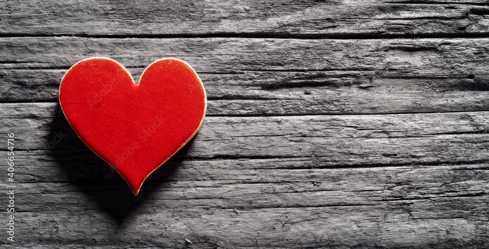 Red heart on a wood background concept for love, dating and romance with copy space Red heart on a wood background concept for love, dating and romance with copy space