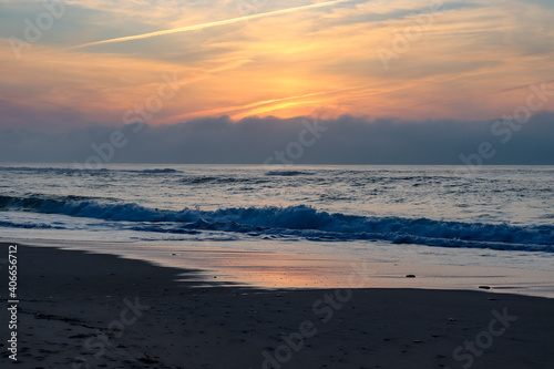 Cloudy sunset over the ocean and a little beach © Alexander Leven