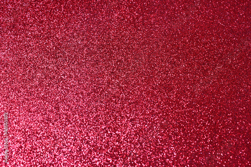 Abstract red background glitter and shimmer with bokeh effect. Background for festive design, new year and christmas. Stock photography. 