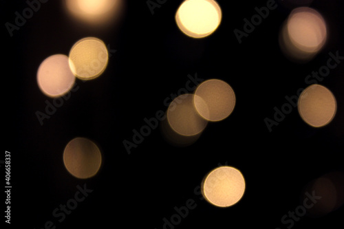 Yellow circles on black background bokeh effect. 