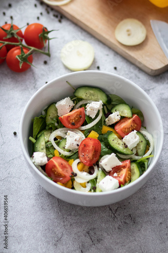 Green vegan salad made from a mixture of green leaves and vegetables.