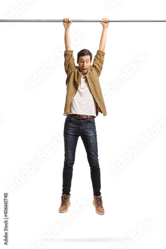 Scared man hanging and holding onto a bar