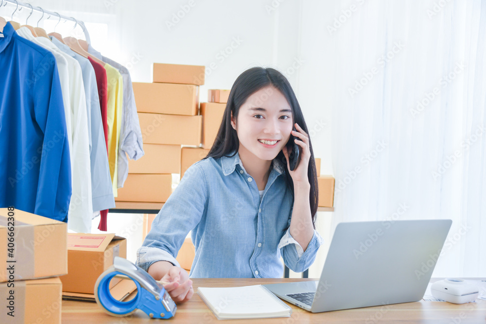 Female startup small business owner working with notebook computer at office. Online selling. E-commerce. Female startup small business owner working with notebook computer at office. Online selling. E-commerce.