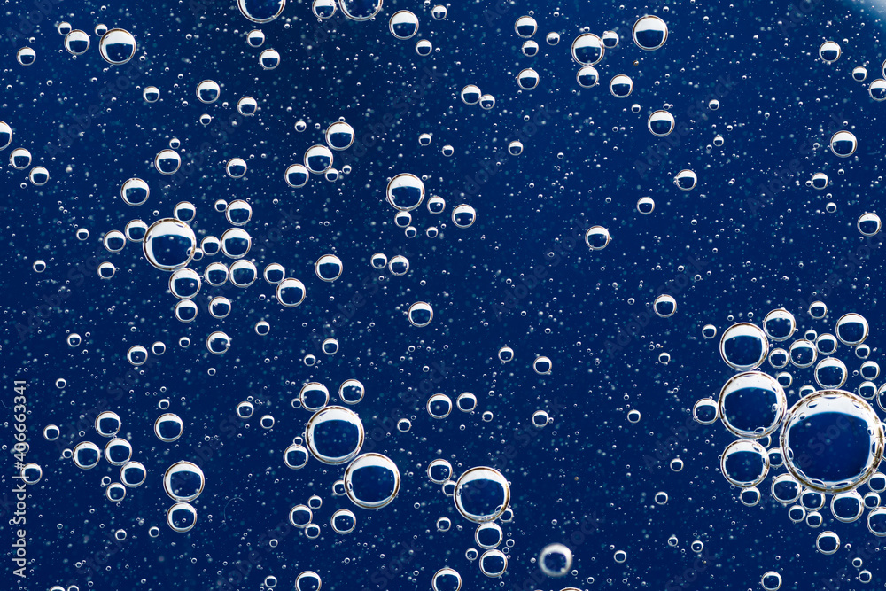 Large beautiful Oxygen bubbles underwater on a blue background macro.