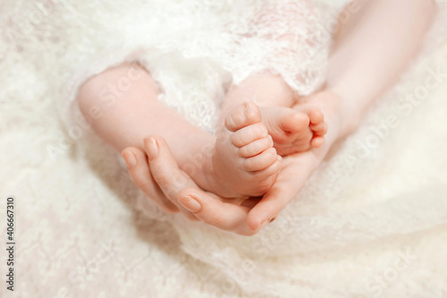 Baby feet in mother hands. Mom and her child. Happy family concept. Beautiful conceptual image of Maternity