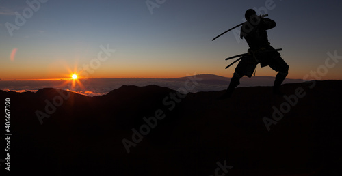 Silhouette of a Japanesesamurai with sword training during sunset