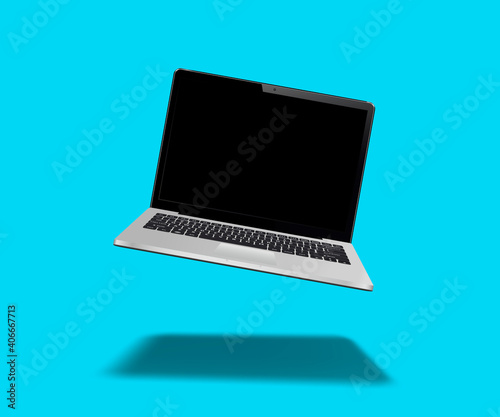 Laptop floating on blue background