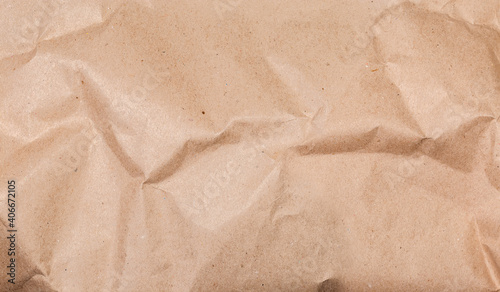 Background of gray brown slightly crumpled wrapping paper, fragment, texture