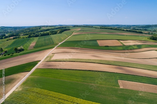 Village country farming shapes in field aerial drone photo