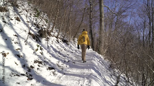 Man hiking Medvednica mountain alone during winter sunny day, Croatia. photo