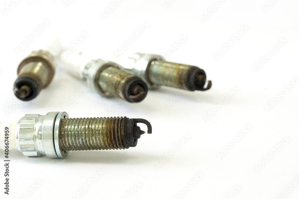 Selective focus of Black, oily deposits on the electrodes and insulator tip points to an oil-fouled plug on spark plug with copy space on white background Selective focus of Black, oily deposits on the electrodes and insulator tip points to an oil-fouled plug on spark plug with copy space on white background