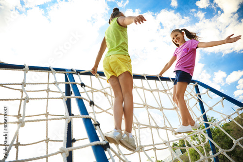 Cute children on playground rope climber outdoors. Summer camp © New Africa
