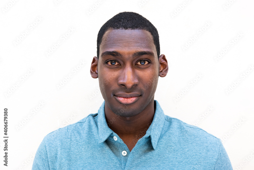 Obraz premium Close up handsome young black man against isolated white background