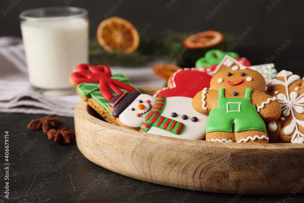 Tasty Christmas cookies on black table, closeup