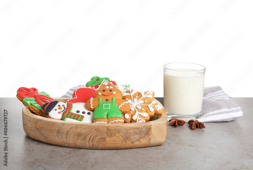 Obraz premium Tasty Christmas cookies near glass of milk on table against white background