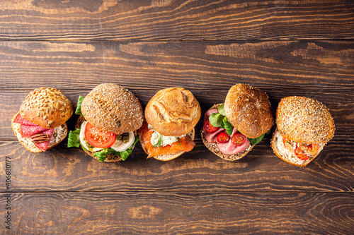 Assorted sandwiches on wooden background. Healthy food concept with copy space. Top view.