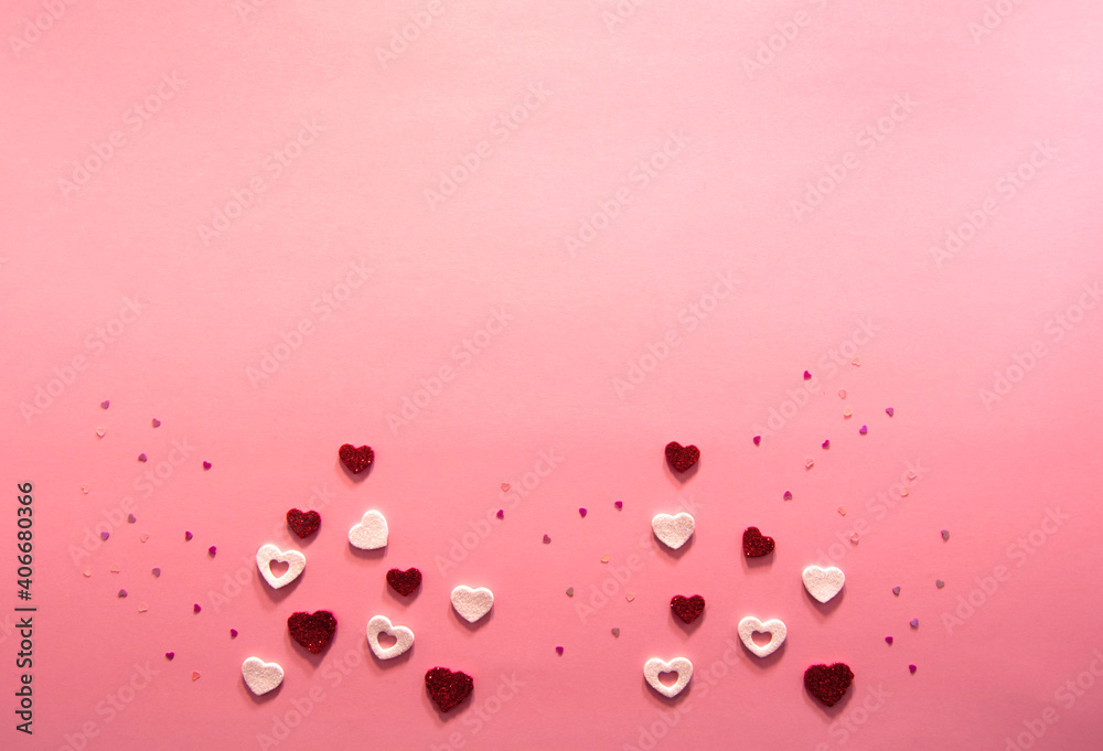 Decorations for design for valentine's day on a pink background. Sparkling white and red paper hearts of different sizes. Flat lay top view. Copy space