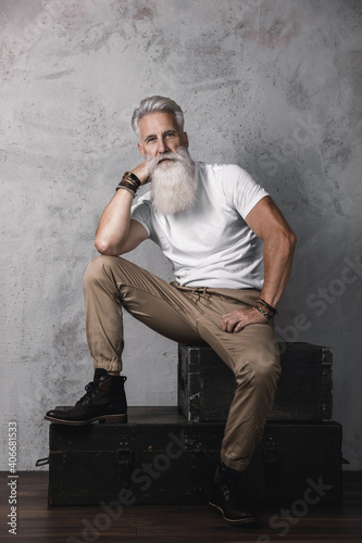 Handsome bearded senior man posing in studio