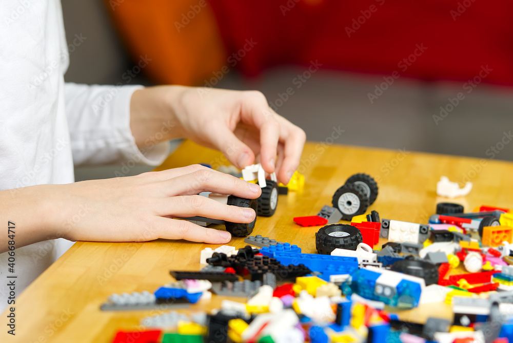 young boy playing with plastic construction toys at home. young boy playing with plastic construction toys at home.