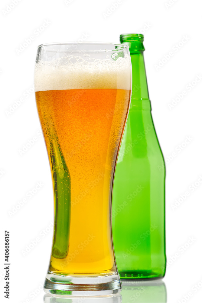 glass with beer and green bottle isolated on white