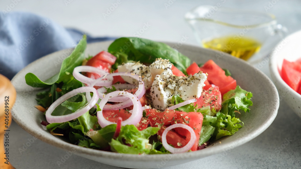 Greek salad in bowl closeup view. Healthy vegetable salad with feta cheese