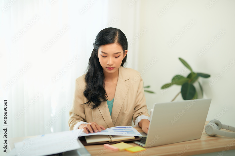 Focused woman journalist freelancer working online on laptop, sitting at desk at home Focused woman journalist freelancer working online on laptop, sitting at desk at home