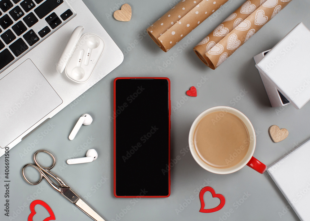 Red Mobile phone and cup of coffee near laptop. Valentines Day concept Red Mobile phone and cup of coffee near laptop. Valentines Day concept