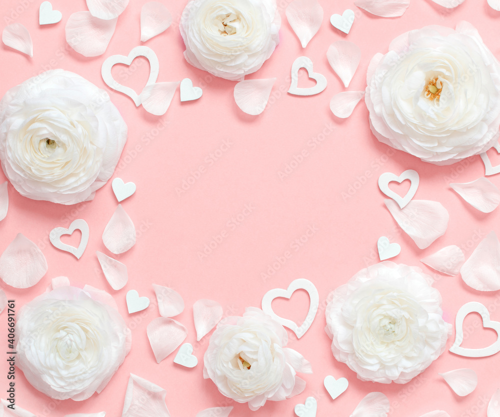 Frame made of cream flowers, petals and hearts on a light pink background