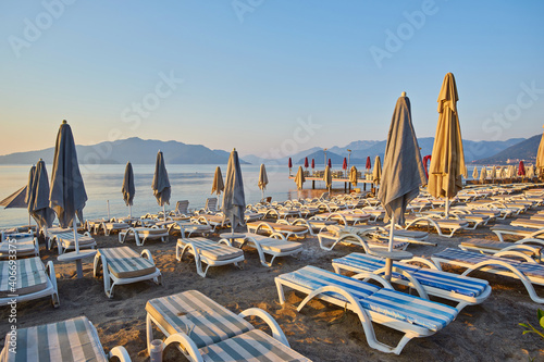 sandy beach without people and with sun loungers, umbrellas, palm trees, Marmaris © Ryzhkov Oleksandr