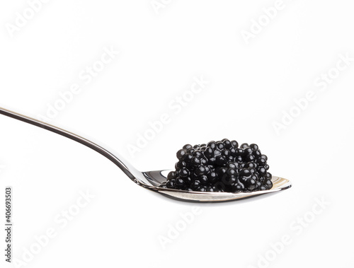 fresh grainy black paddlefish caviar in metal spoon on white background,