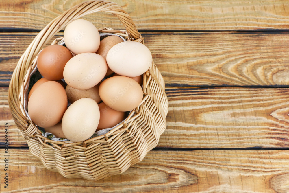 straw basket with eggs on wooden background. High quality photo straw basket with eggs on wooden background. High quality photo