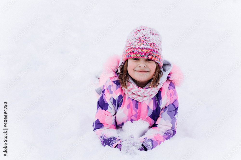 Little happy cheerful girl playing outdoors in winter snow park Little happy cheerful girl playing outdoors in winter snow park