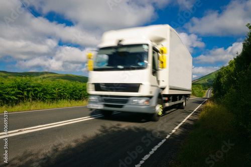 White truck on road motion blur