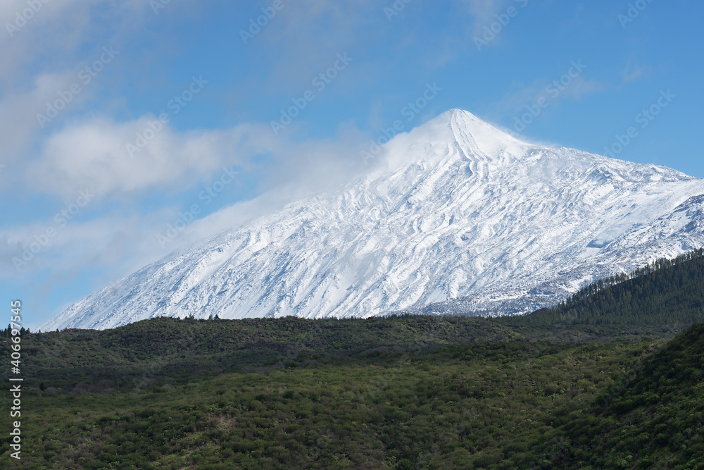 Pico del Teide mountain volcano in snow, bright blue sky. Teide National Park, Tenerife, Canary Islands, Spain Pico del Teide mountain volcano in snow, bright blue sky. Teide National Park, Tenerife, Canary Islands, Spain