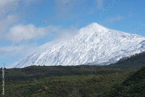 Pico del Teide mountain volcano in snow, bright blue sky. Teide National Park, Tenerife, Canary Islands, Spain