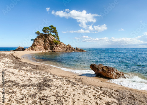 beautiful sand beach in Costa Brava, Spain, with a cloudy sky and a sunny day of summer photo