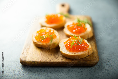 Red caviar on toast with dill