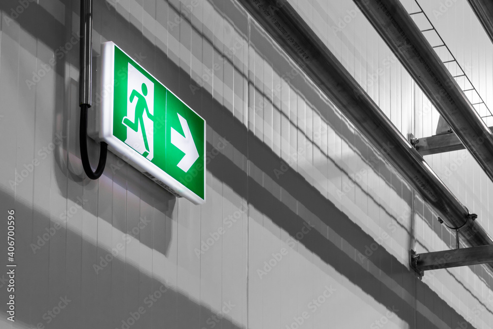 green emergency exit sign on a wall green emergency exit sign on a wall