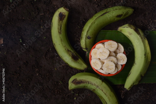 green banana fruit on the table with dark background