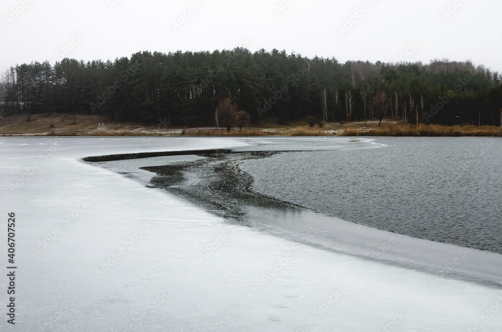 Completely unfrozen lake surface. There is no snow in the nature reserve due to the warm winter Completely unfrozen lake surface. There is no snow in the nature reserve due to the warm winter