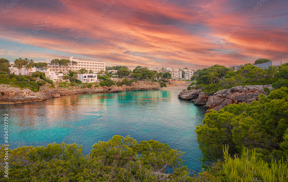 Panorama of the famous Cala dâ€™Or region and Esmeralda beach illuminated at sunset in summertime, Palme de Mallorca - Spain