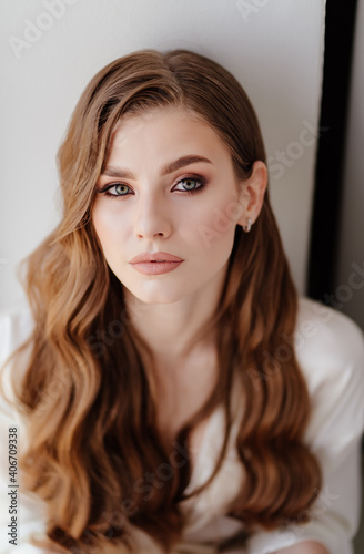 portrait of a beautiful young woman with long hair. Professional makeup. 