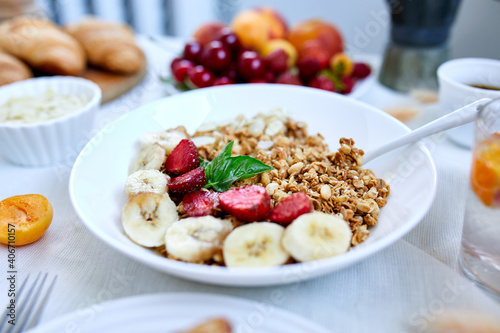 Healthy breakfast bowl, fresh granola, fruits and coffee.