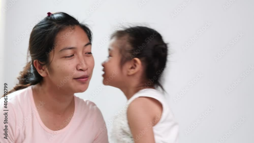 Happy loving family. Mother and daughter child girl playing, hugging, kissing, laughting and spending time together on white background. Mothers day, valentines day, celebration, holiday concept. Happy loving family. Mother and daughter child girl playing, hugging, kissing, laughting and spending time together on white background. Mothers day, valentines day, celebration, holiday concept.