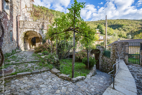 Fototapeta Naklejka Na Ścianę i Meble -  View of empty stone streets of an abandoned mountain village with a few remaining residents