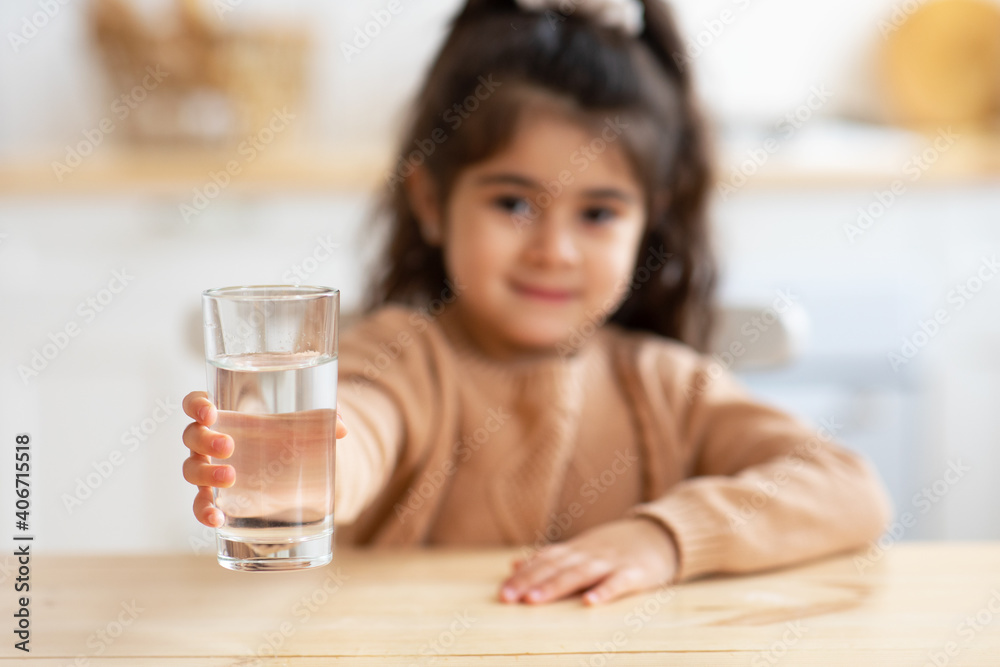 Closeup Shot Of Cute Little Girl Holding Glass Of Water In Hand Closeup Shot Of Cute Little Girl Holding Glass Of Water In Hand