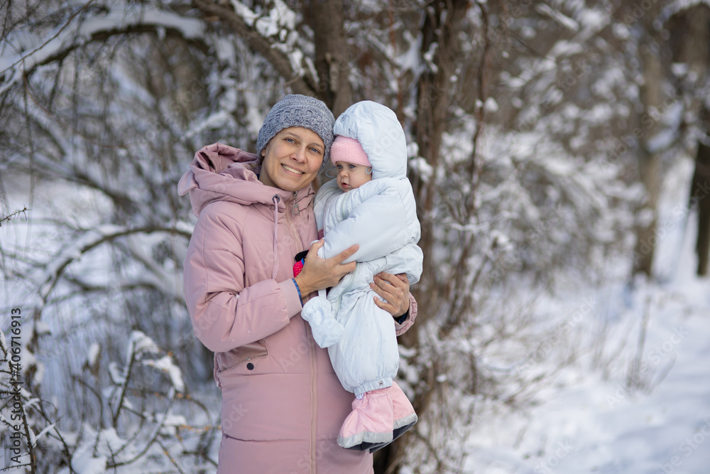 A woman with a baby on a walk in winter