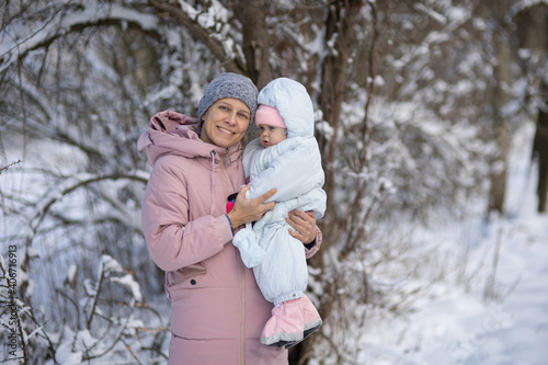 A woman with a baby on a walk in winter