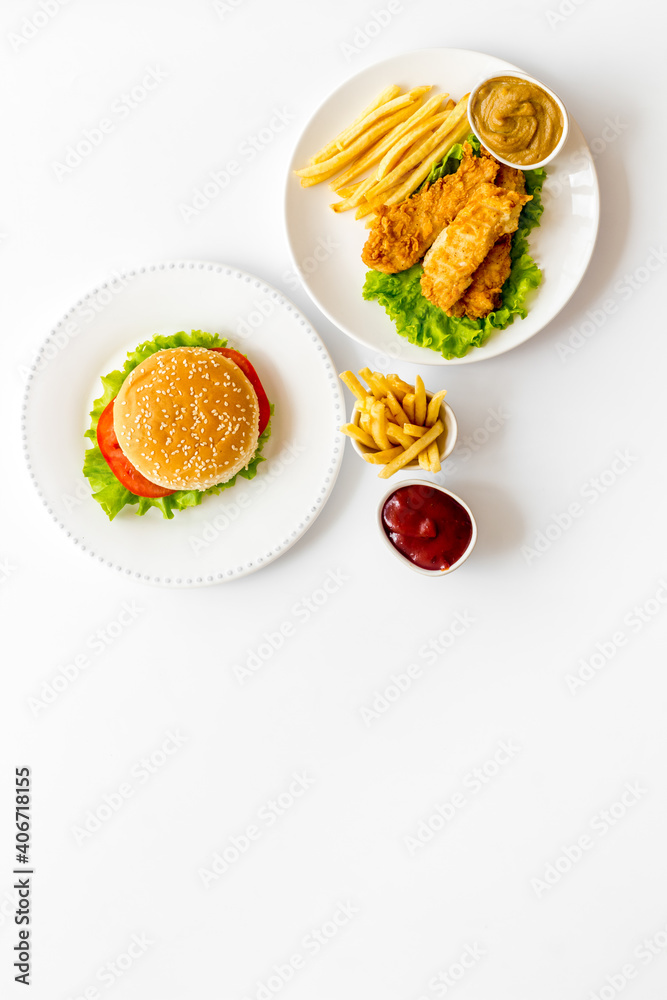 Overhead view of fast food - burger and french fries, flat lay Overhead view of fast food - burger and french fries, flat lay